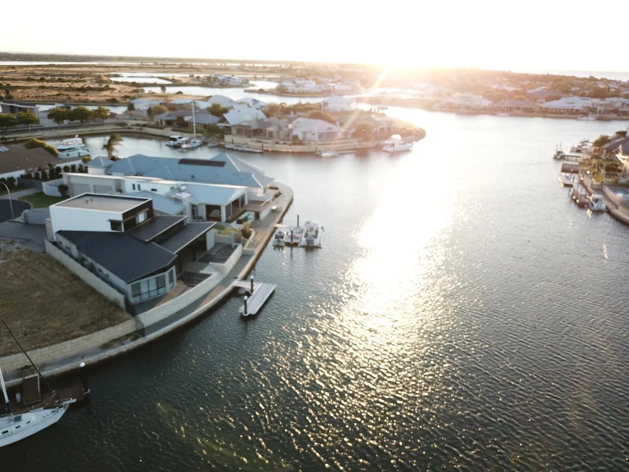Aerial view of homes and jetties along a Port Geographe canal