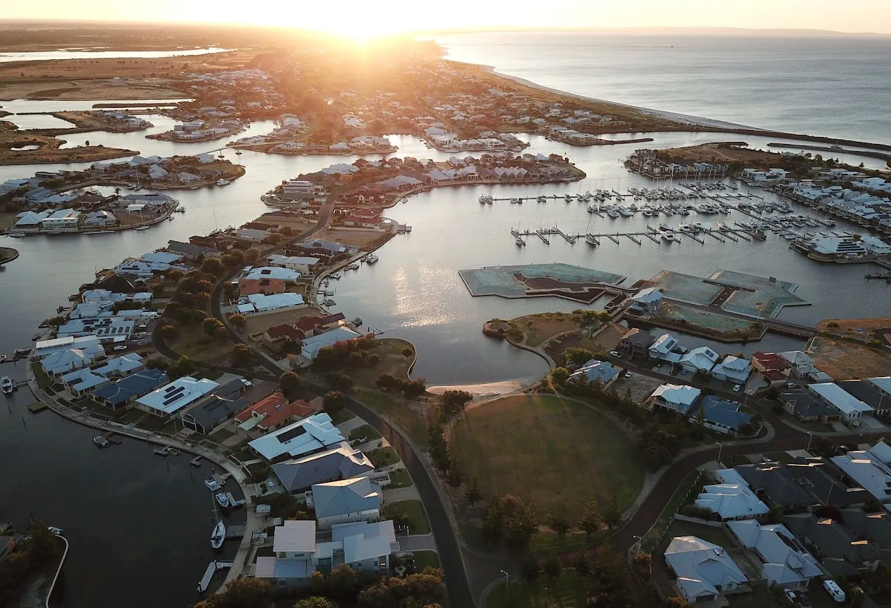 Aerial view of Port Geographe's canals with the sun low over Geographe Bay