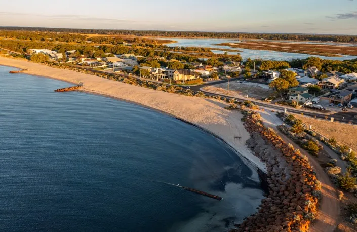 Aerial view of the curving beach east of the Port Geographe breakwater